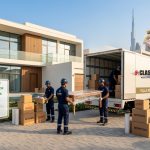 Professional movers in Business Bay carefully packing and relocating household furniture in a Dubai apartment.